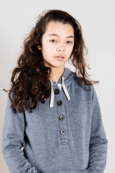 Teen with lazy face wearing a blue sweatshirt while posing - Fotoğraf, Görsel