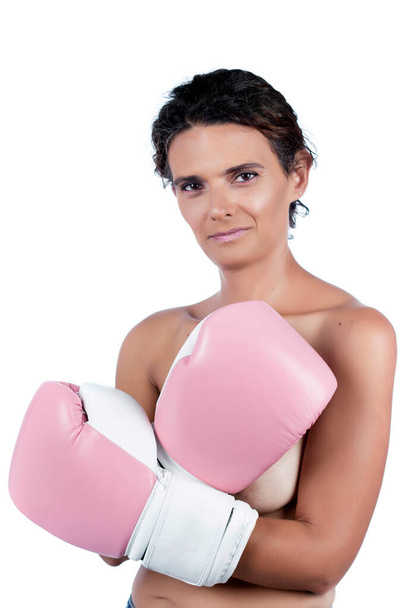 Nude young woman with pink boxing gloves, depicting a fight against breast cancer awareness. - Foto, afbeelding