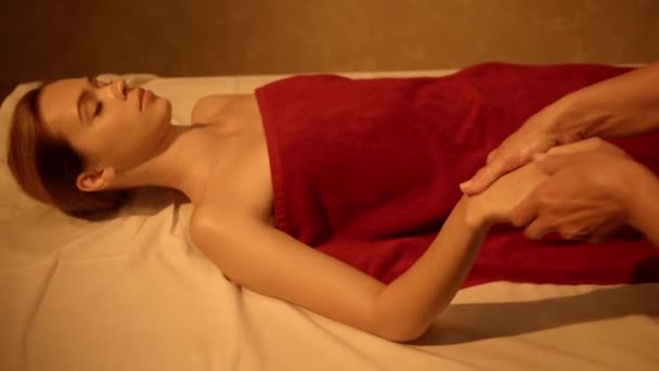 client with closed eyes receiving hand massage from masseur in spa salon - Footage, Video