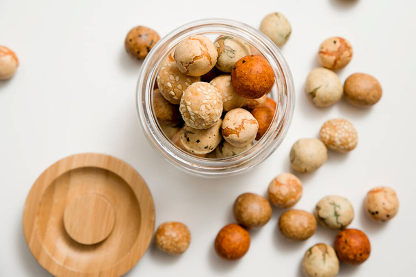 Japanese Rice Nuts "Dragon eggs". Ester desert. Idea for food decoration. Natural color balls with sesame seeds. - Fotó, kép