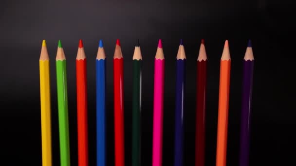 Colored pencils on black background slow motion footage - Footage, Video