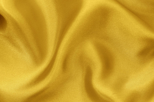 Golden yellow fabric cloth texture for background and design art work, beautiful crumpled pattern of silk or linen. - Foto, Imagen