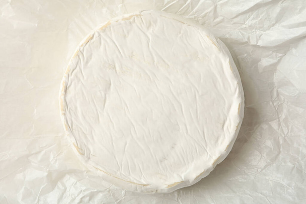 Delicious camembert cheese on paper, close up - Photo, Image