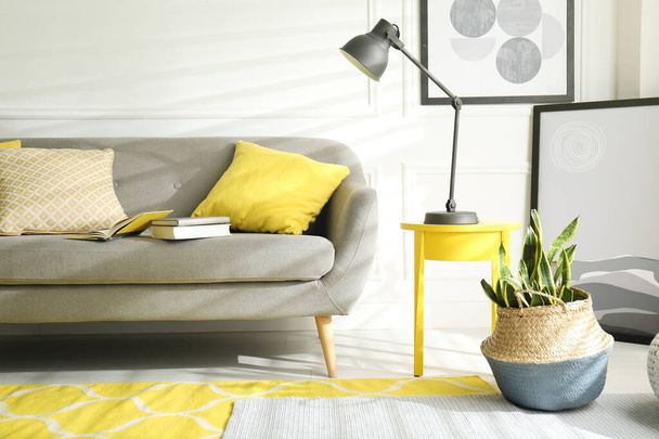 Stylish living room with sofa. Interior design in grey and yellow colors - Fotoğraf, Görsel
