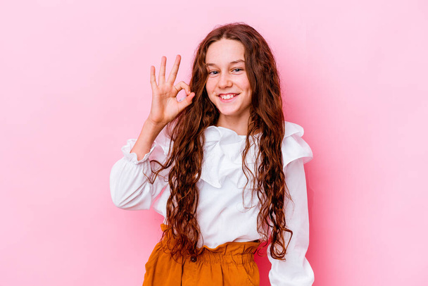 Little caucasian girl isolated on pink background cheerful and confident showing ok gesture. - Φωτογραφία, εικόνα