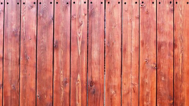 graphic resource textured wooden background of smooth reddish-brown planks covered with wood stain, emphasizing the texture of the cut of the tree, bright country style backdrop - Foto, imagen