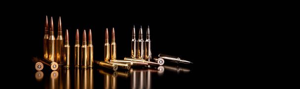 Bullet isolated on black background with reflexion. Rifle bullets close-up on black back. Cartridges for rifle and carbine on a black. - Photo, image