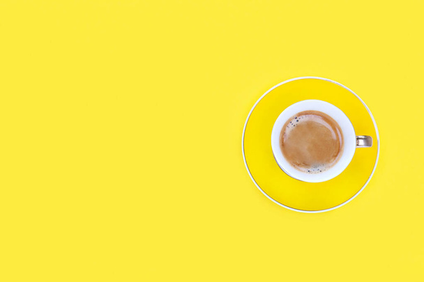 Coffee cup on yellow background. Flat lay. Copy space. Top view image . - Фото, зображення