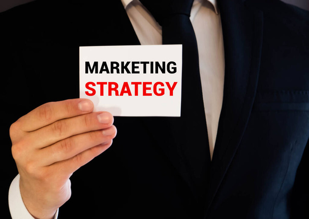 businessman holding a marketing strategy sign, concept - Foto, Imagem