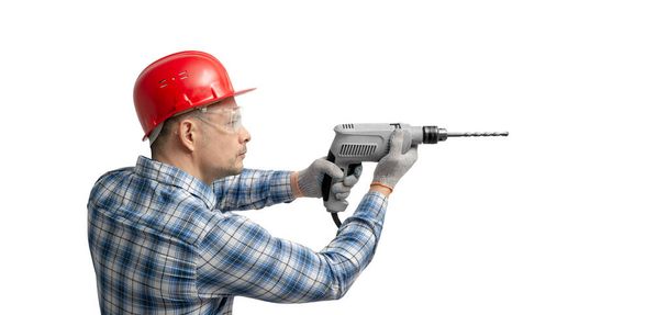 worker handyman or builder worked with construction tools - electric drill perforator , on white background, isolated. Repair service and construction concept - Foto, immagini