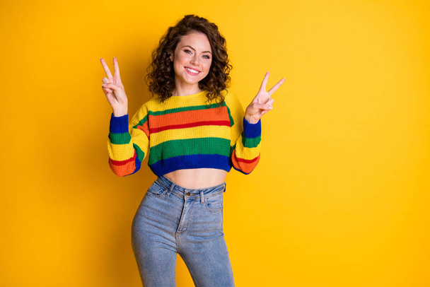 Photo portrait of cute girl showing two v-signs isolated on vivid yellow colored background - Foto, immagini