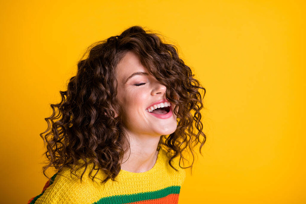 Photo of sweet laughing lady wearing casual colorful sweater closed eyes isolated yellow color background - Foto, Bild