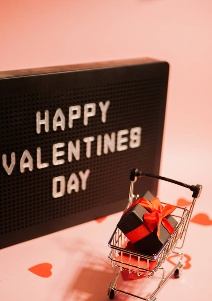 Valentines day sale. Shopping card with gift box. Message board background. Online shopping. Vertical orientation  - Fotó, kép