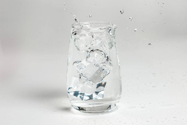 clean water is poured into a glass cup. ice in a glass. - Photo, image