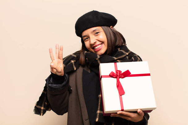 young pretty woman holding a gift - Fotó, kép