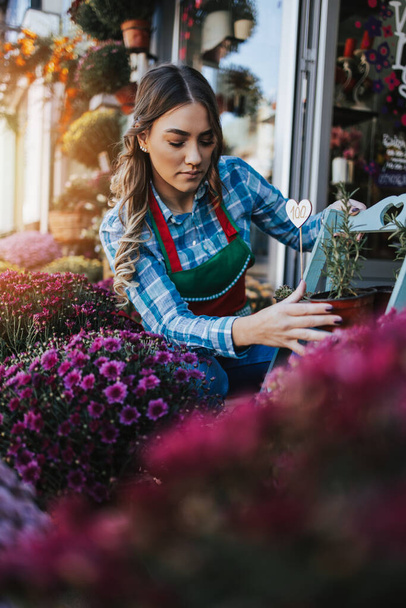 Young adult woman working in city street flower shop or florist. Small business concept. - Φωτογραφία, εικόνα