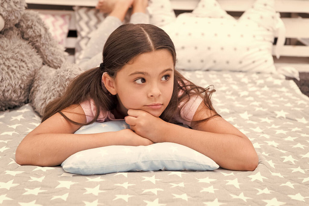Dreaming in bedroom. Relax and ease transition to sleep. Relaxation concept. Mental and physical relaxation. Ways to relax before bedtime. Relaxation Exercises for Falling Asleep. Little girl pajamas. - Foto, afbeelding