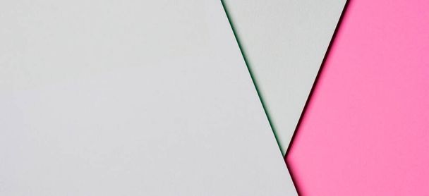 Αφηρημένο χρωματιστό χαρτί υφή φόντο. Ελάχιστα γεωμετρικά σχήματα και γραμμές σε ανοιχτό πράσινο και παστέλ ροζ χρώματα - Φωτογραφία, εικόνα