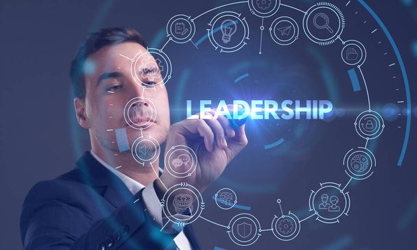 Business, Technology, Internet and network concept. Young businessman working on a virtual screen of the future and sees the inscription: Leadership - Zdjęcie, obraz