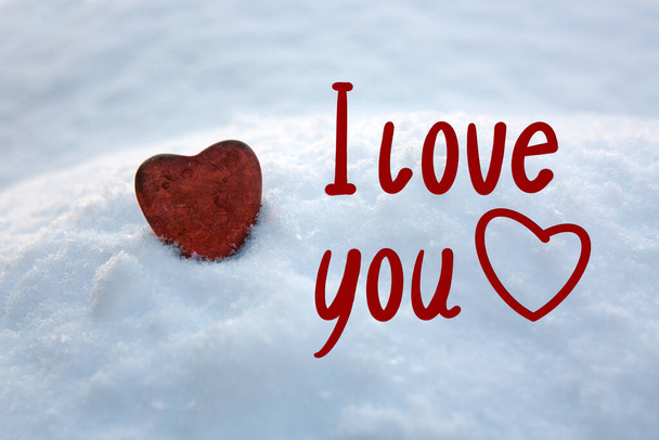 Red stone heart in white snow.Valentines day card. - Фото, изображение