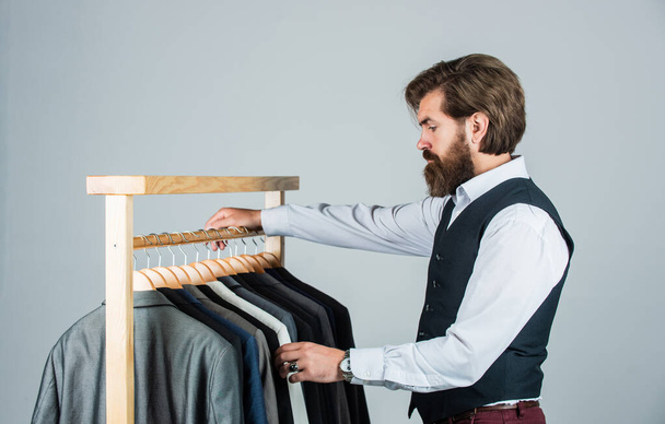 Shopper hipster man in fitting room menswear store, choosing clothes concept - Photo, Image