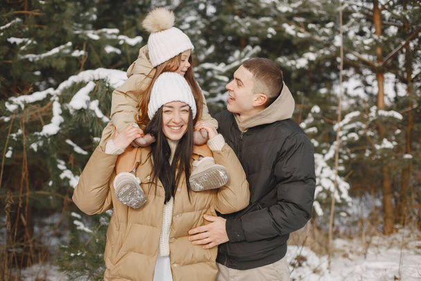 Family in winter clothes play in winter forest - Foto, Imagem