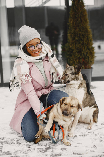 African woman walks with dogs outdoors - Foto, Imagem