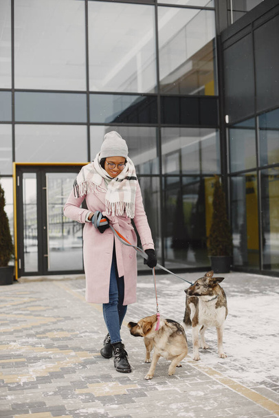 African woman walks with dogs outdoors - Photo, Image