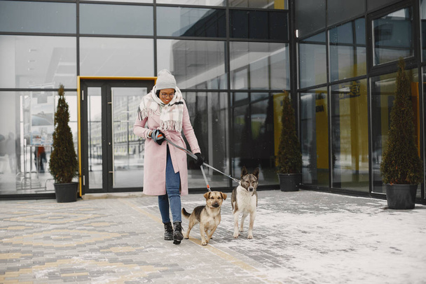 African woman walks with dogs outdoors - Foto, Bild