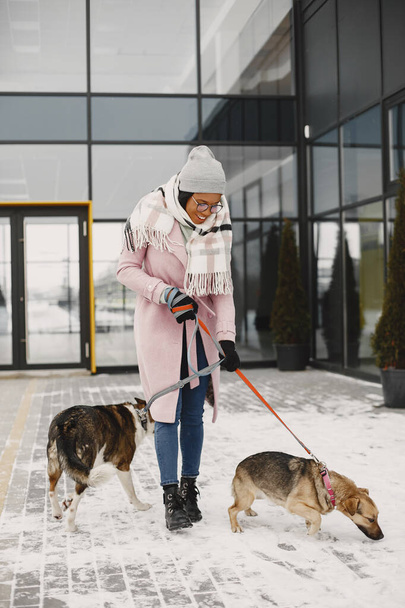 African woman walks with dogs outdoors - Valokuva, kuva