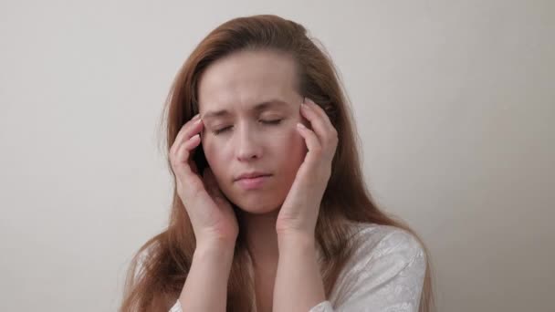 Young women massaging whiskey and head, feeling unwell, insomnia. Woman with headache close-up. Suffering from overwork, fatigue, tormented by migraines, panic attacks and high blood pressure. - Footage, Video