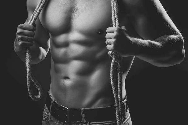 Muscular man with rope. Sexy strong young man with muscular body. - Foto, Imagem