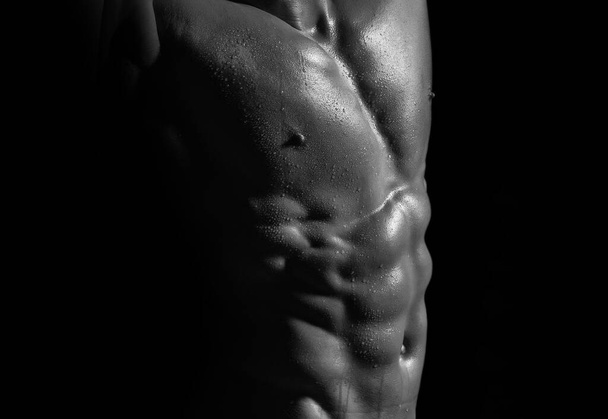 Sexy strong bare torso with abs and muscular male chest on black. - Fotografie, Obrázek