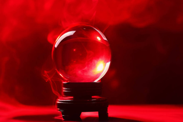 Crystal ball of fortune teller in smoke on color background - Photo, Image