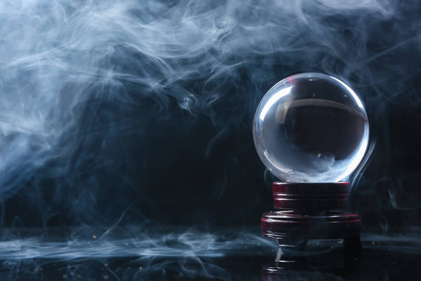 Crystal ball of fortune teller in smoke on dark background - Photo, Image