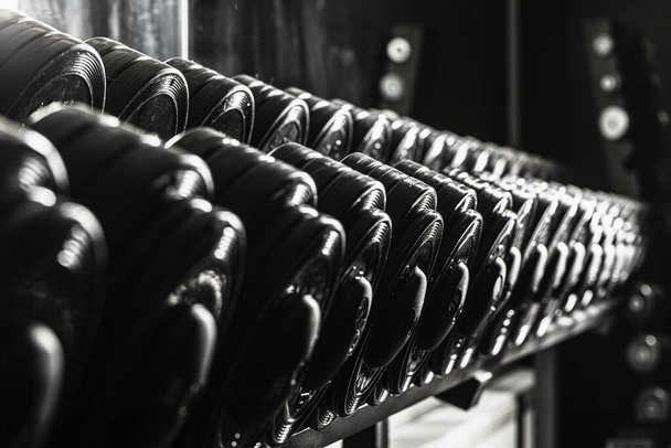 Sports equipment in gym. Dumbbells of different weight close up - Foto, Imagem