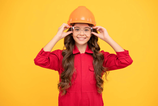 happy teenager girl in protective eyeglasses and helmet, engineer. - Photo, Image