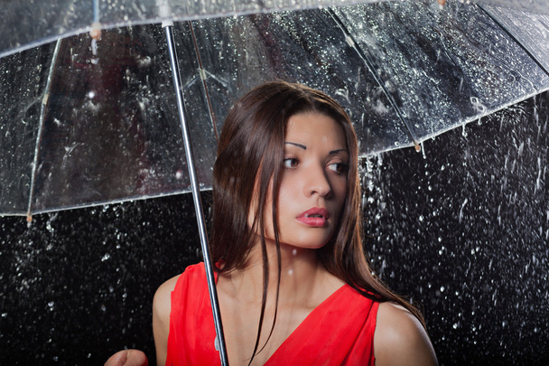 Pretty woman with umbrella under - Фото, изображение