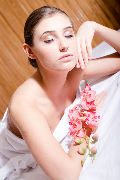 Brunette lying in the spa salon - Photo, image