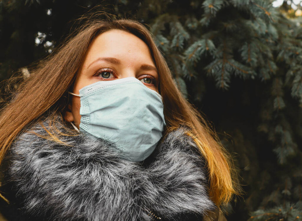 Covid epidemischen Hintergrund mit Frau in Maske. Schöne Mädchen im Kiefernwald - Foto, Bild