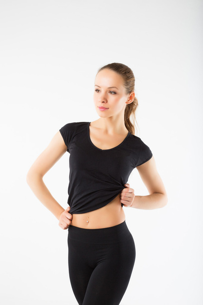 Young sexy athletic woman in black sportswear - isolated on whit - 写真・画像
