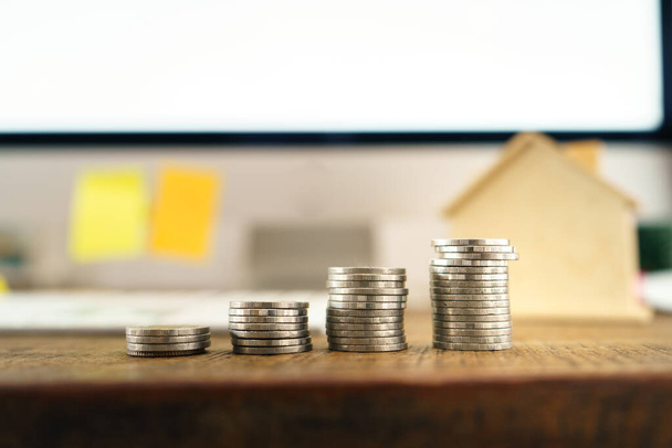 Saving money in front of the desk at home  - Foto, Imagen
