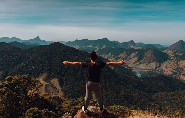 A person with opened hands standing on the mountain - the concept of freedom - Foto, imagen