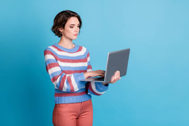 Photo portrait of concentrated serious female freelancer using keeping laptop browsing internet isolated on bright blue color background - Valokuva, kuva