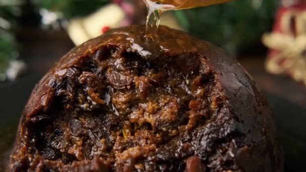 Christmas pudding pours alcohol and ready for fire. British traditional food - Footage, Video