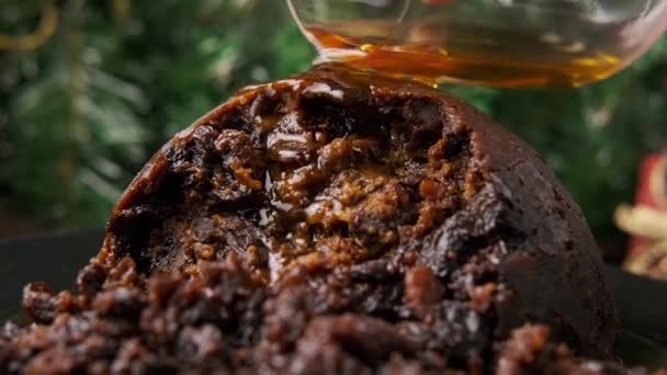 Christmas pudding pours alcohol and set on fire. British traditional food - Footage, Video