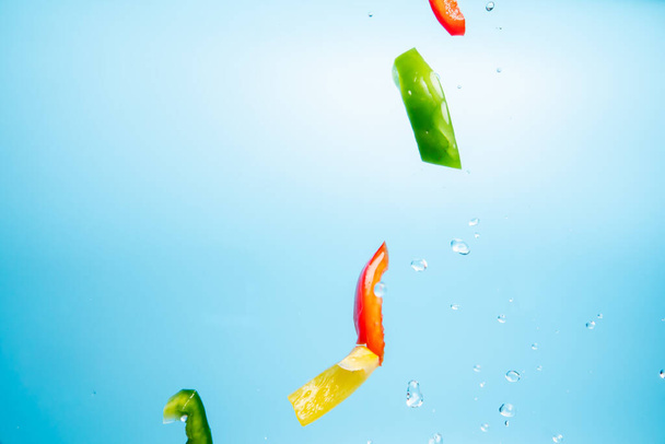 A closeup of the fresh colored peppers on the air - Foto, immagini