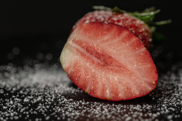 A closeup shot of fresh strawberries on dark background - Foto, Imagen