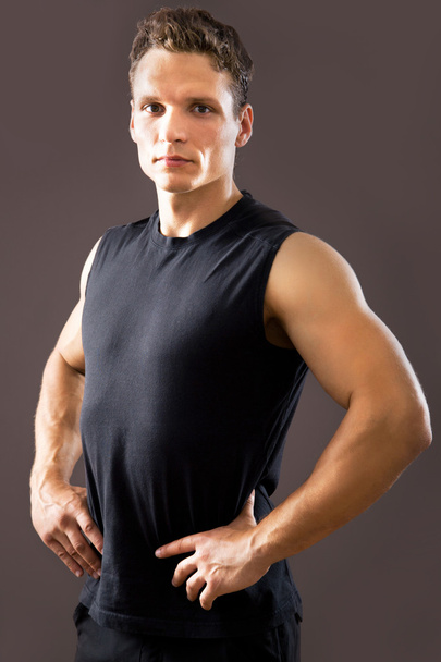Fitness man on a gray background - Foto, imagen