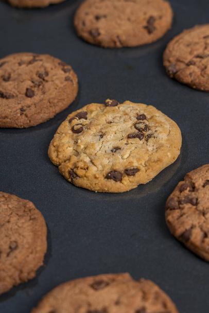 A selective focus shot of chocolate chip cookies on a baking pan - Valokuva, kuva